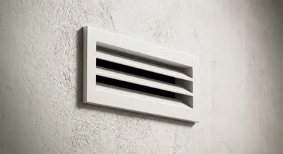 Gros plan minimaliste d'une bouche de VMC parfaitement propre.